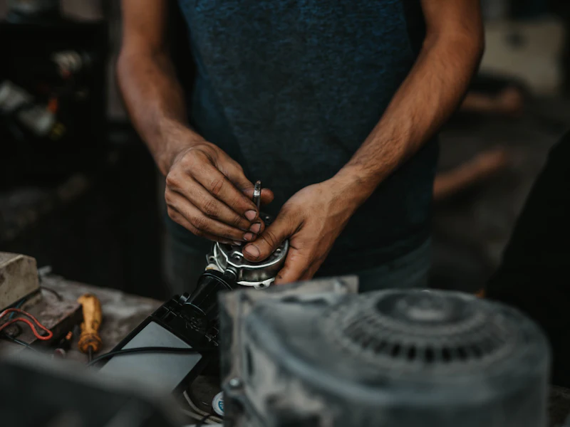Technician stripping down an appliance motor at the bench