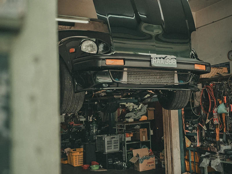 Car raised on a two-post lift for underside inspection