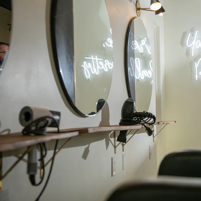 Styling station lit by warm neon signage