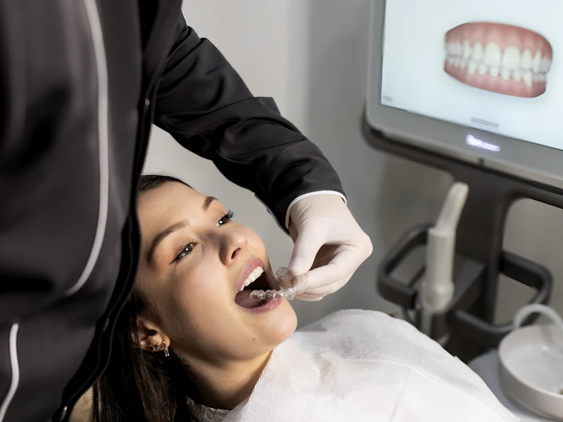 Dentist examining a patient with an intraoral scanner