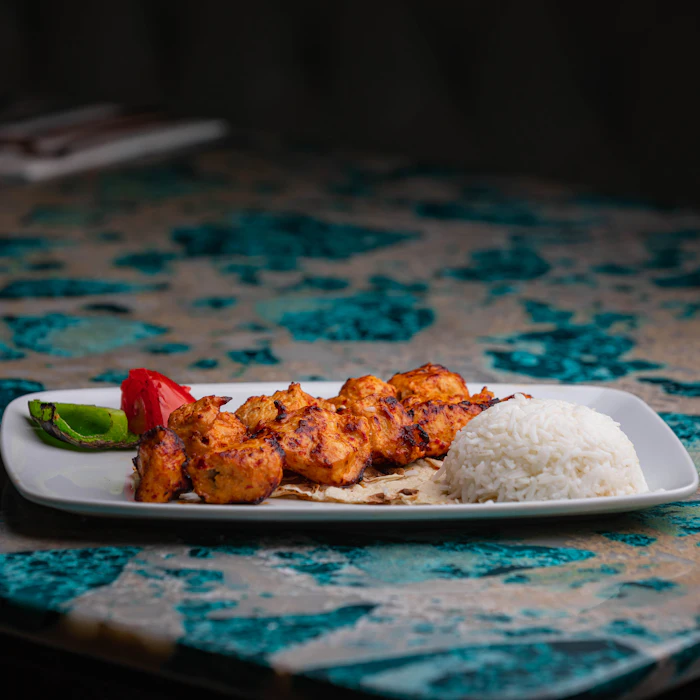 Saffron chicken skewers served with steamed rice