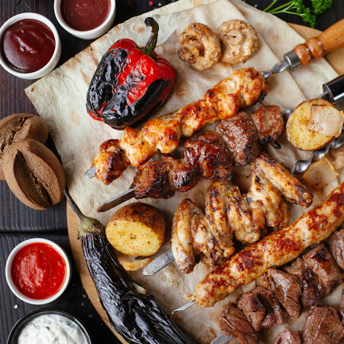 Mixed grill platter with flatbread, grilled tomato and dips