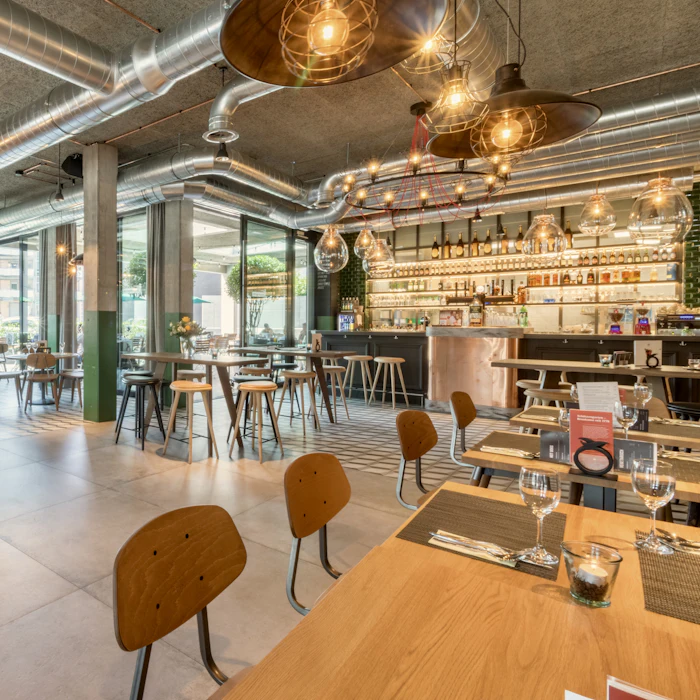 Bright dining room with bar seating and hanging plants