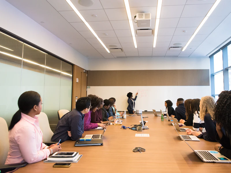 Interpreter working alongside delegates in a boardroom meeting
